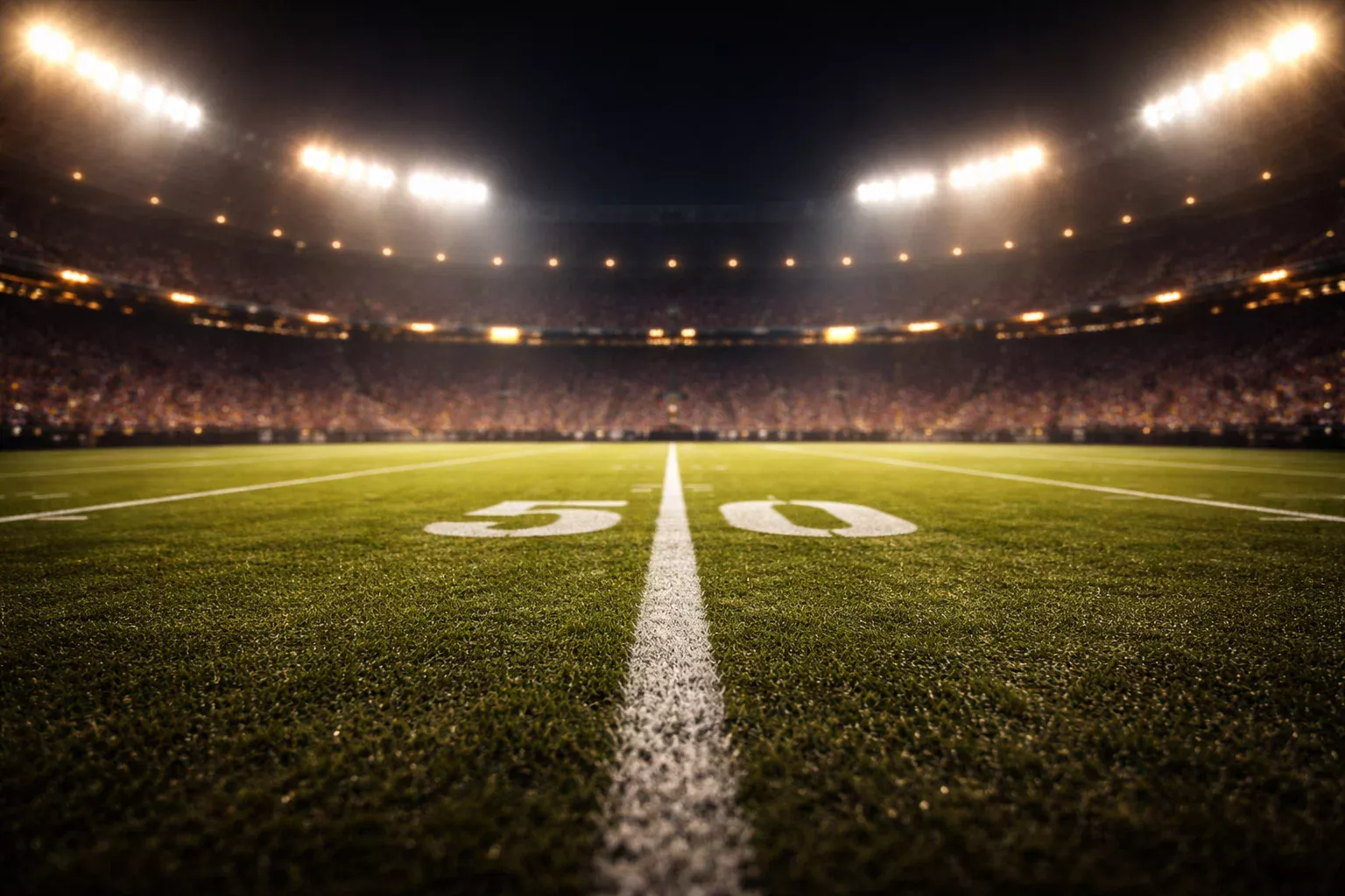 Stade de football américain illuminé la nuit sous les projecteurs